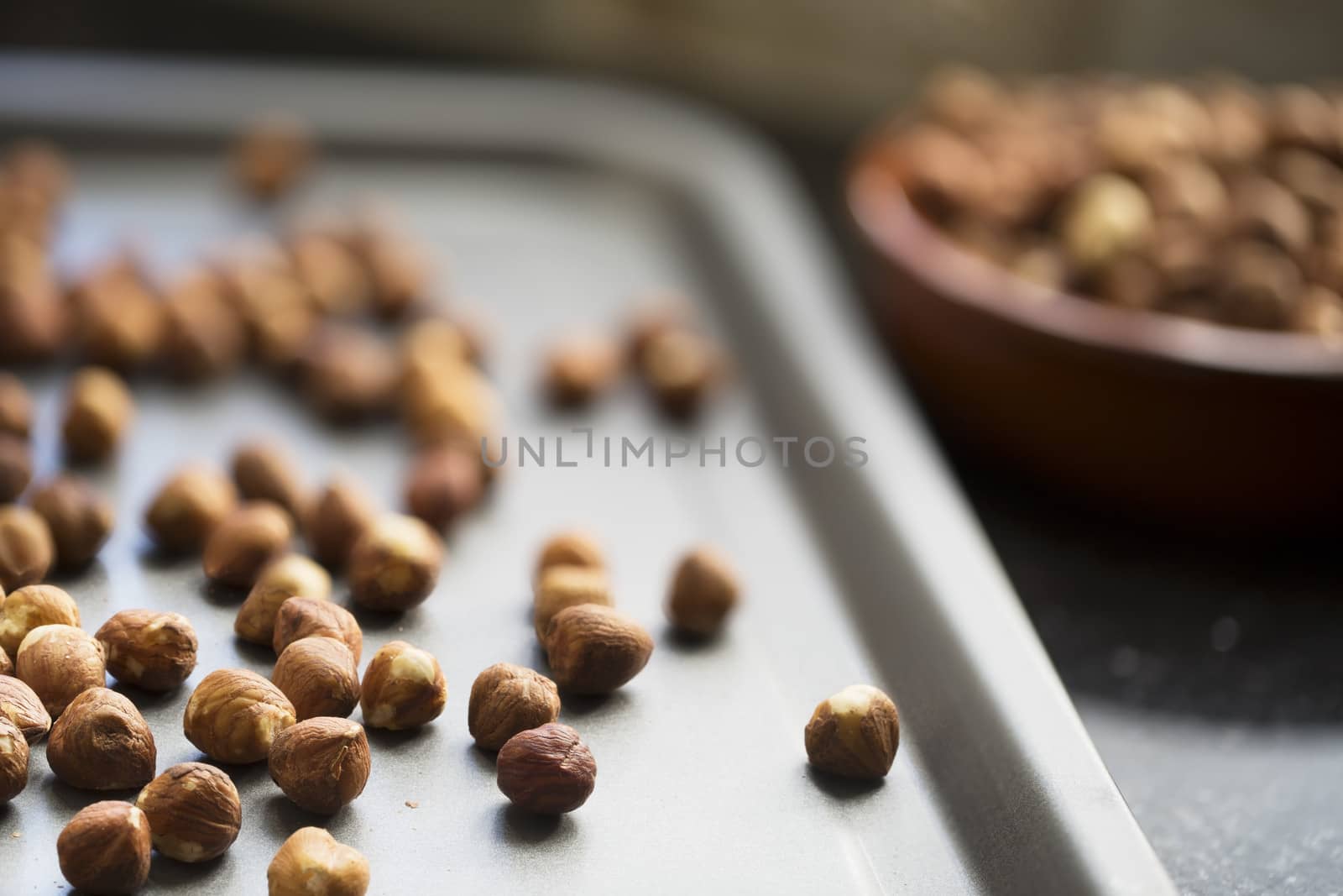 Hazelnuts on baking pan ready for roasting.