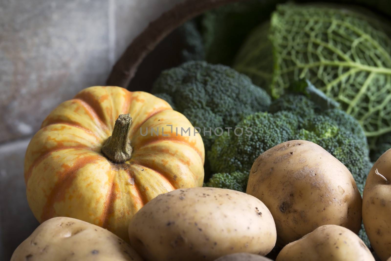 Basket of winter vegetables including broccoli, sweet lightning squash and potatoes.