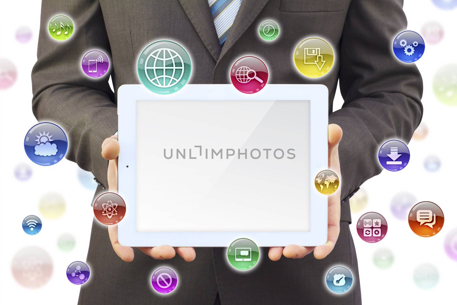 Businessman in a suit holding a tablet computer. Around tablet application icons