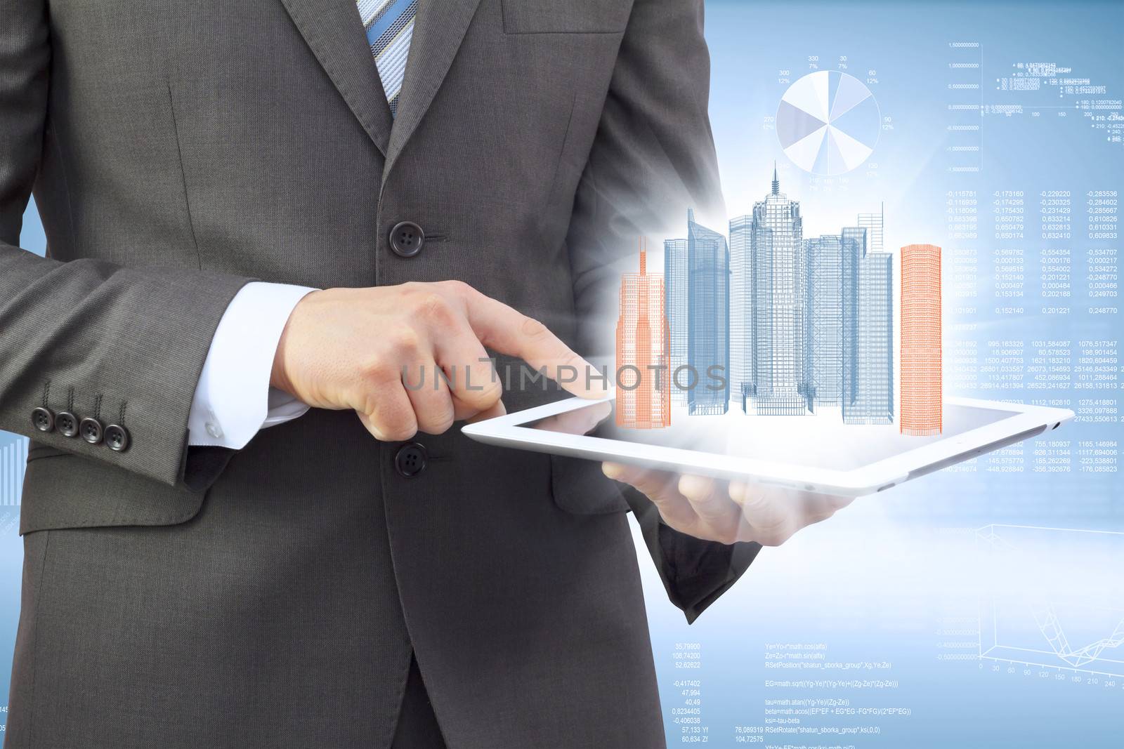Businessman in a suit holding a tablet computer. On the screen of the tablet are skyscrapers