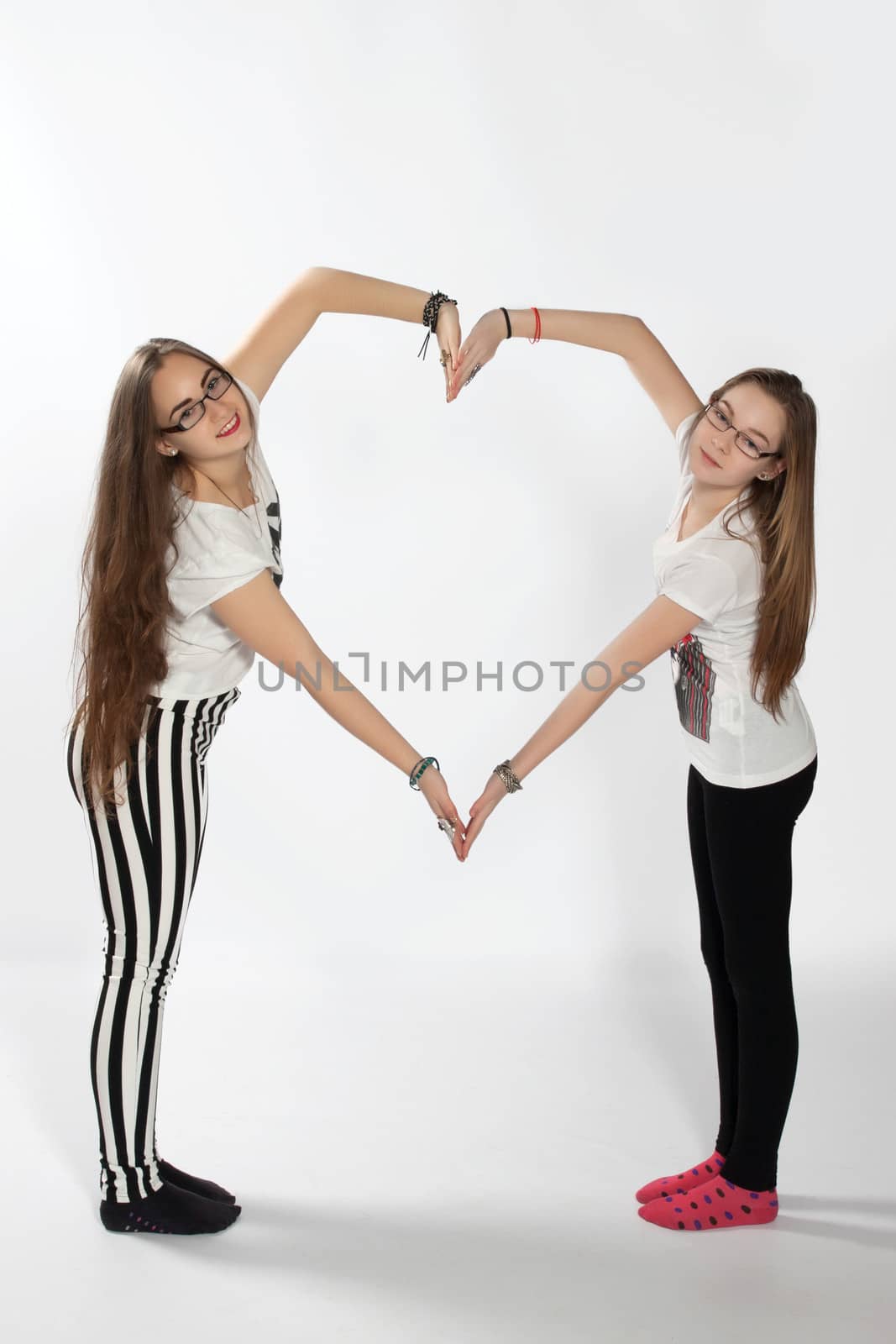 Two sisters created using your hands shape of a large heart
