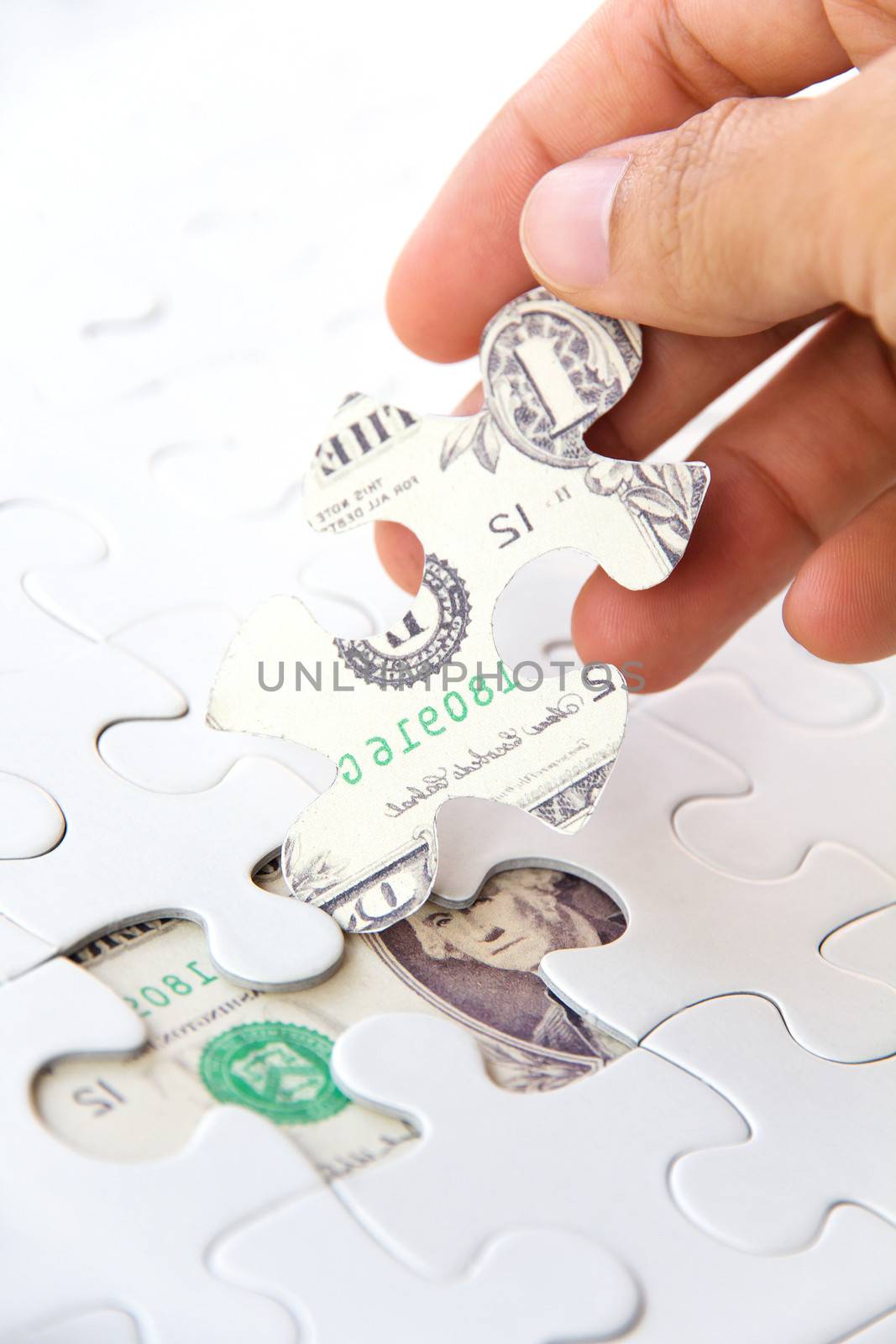 hand holding a puzzle piece, Finance concept by ponsulak