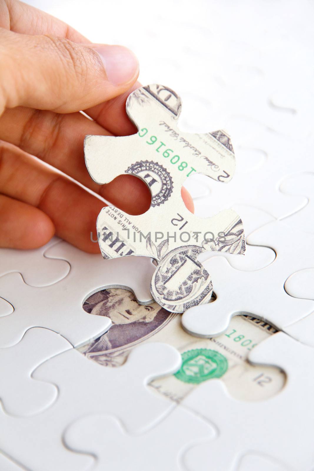 hand holding a puzzle piece, Finance concept by ponsulak