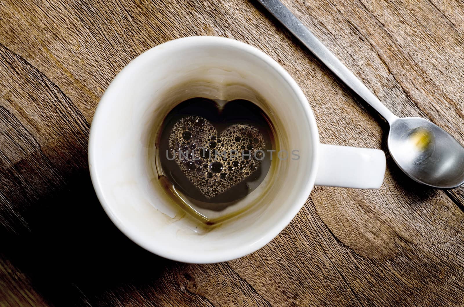 cup coffee with heart symbol on a wooden table  background 