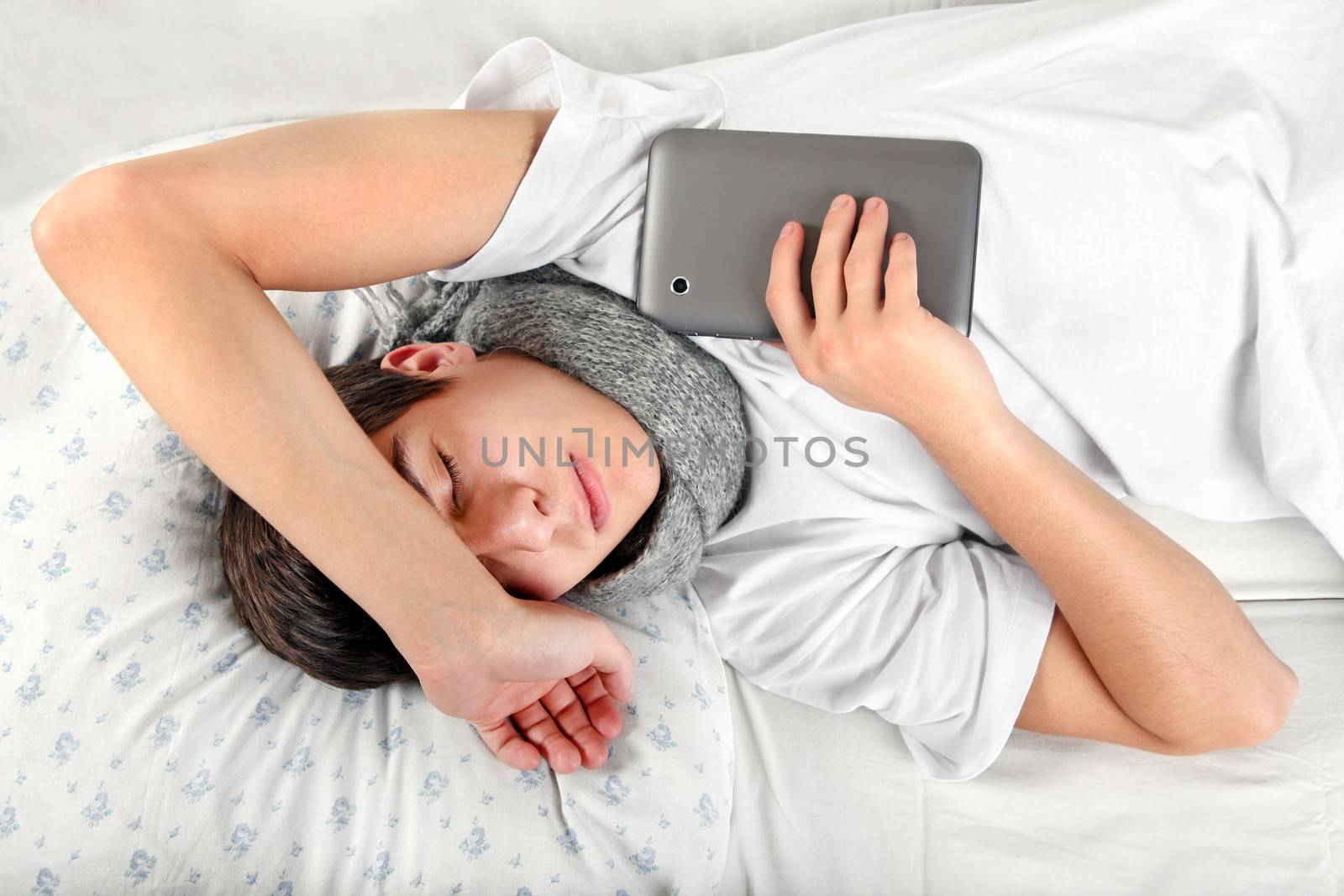 Young Man sleeps with Tablet Computer by sabphoto