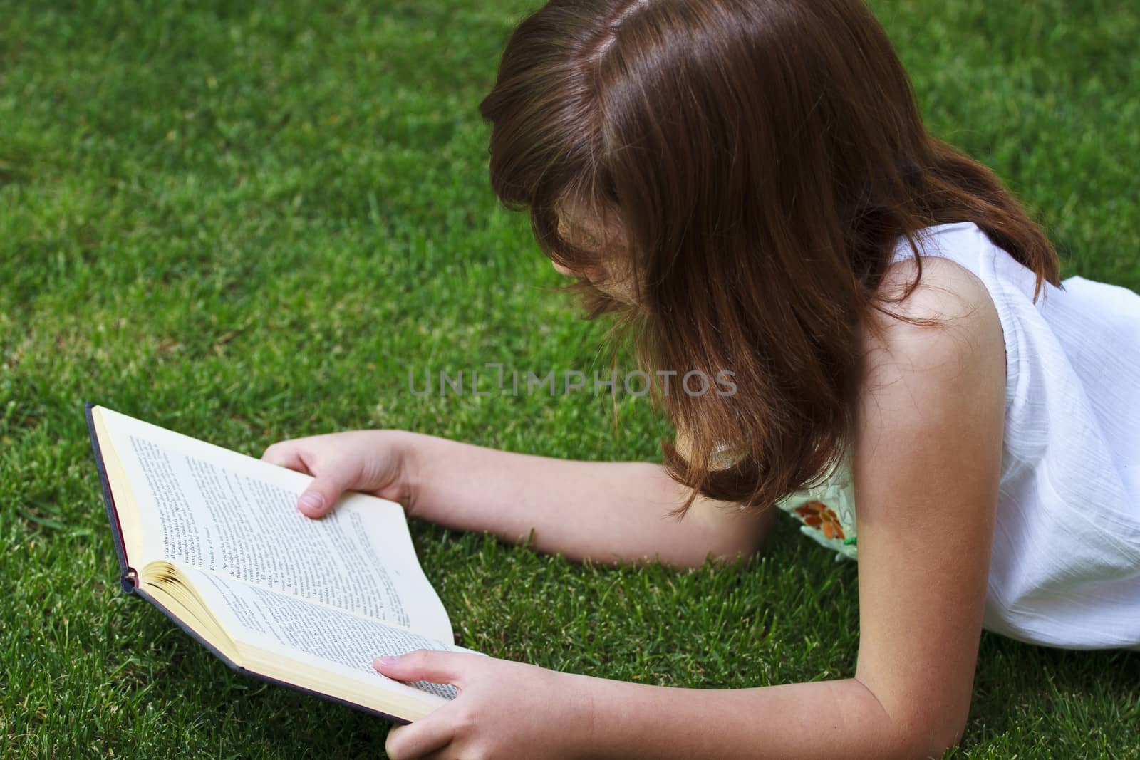 Tale.Young beautiful girl reading a book outdoor by FernandoCortes