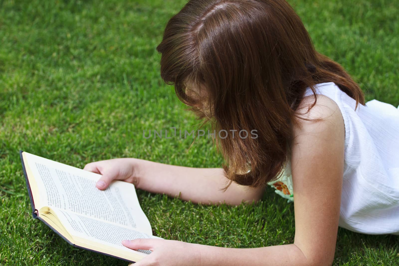Education.Young beautiful girl reading a book outdoor