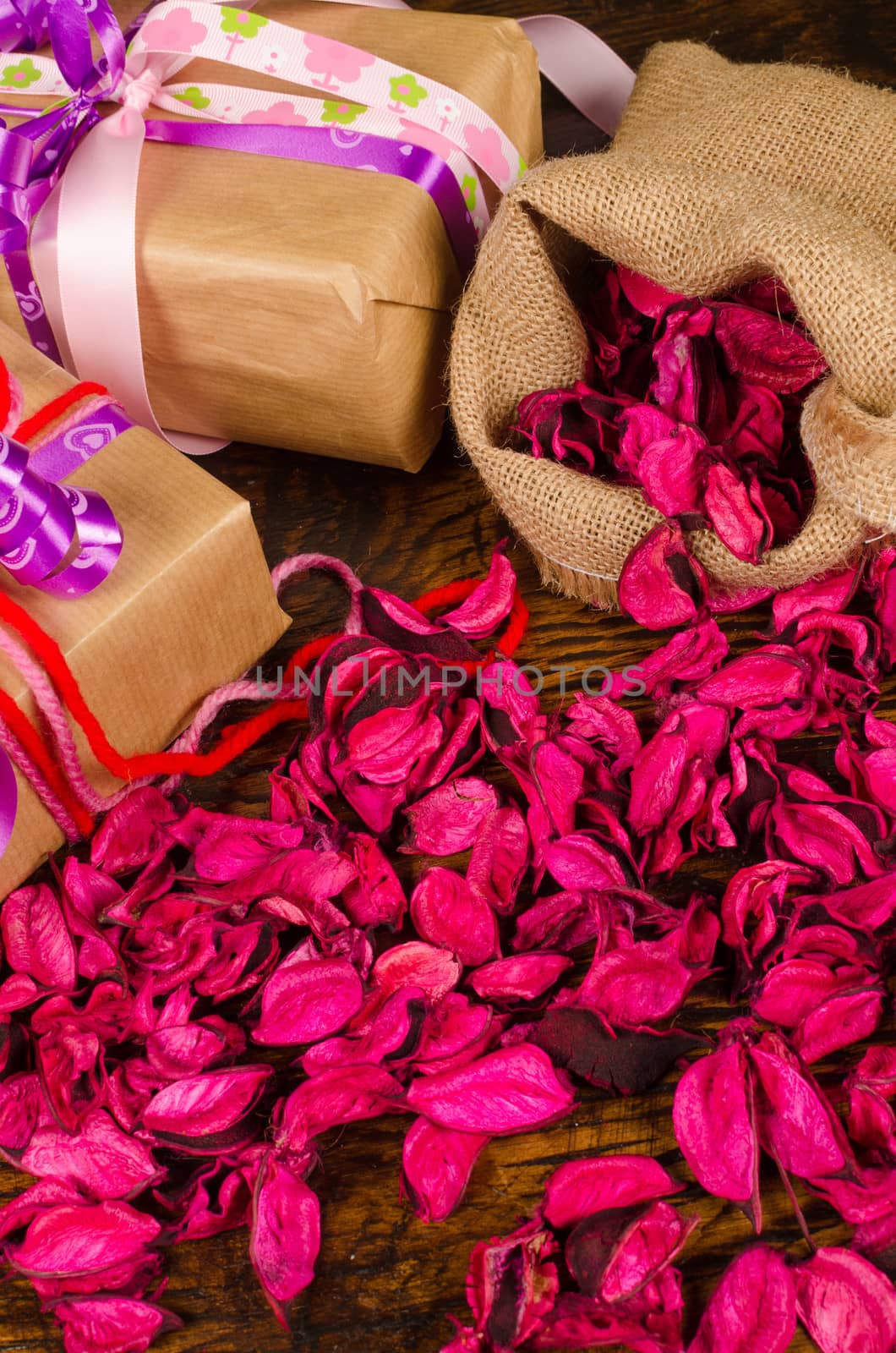 Valentine gifts surrounded by dried flower petals