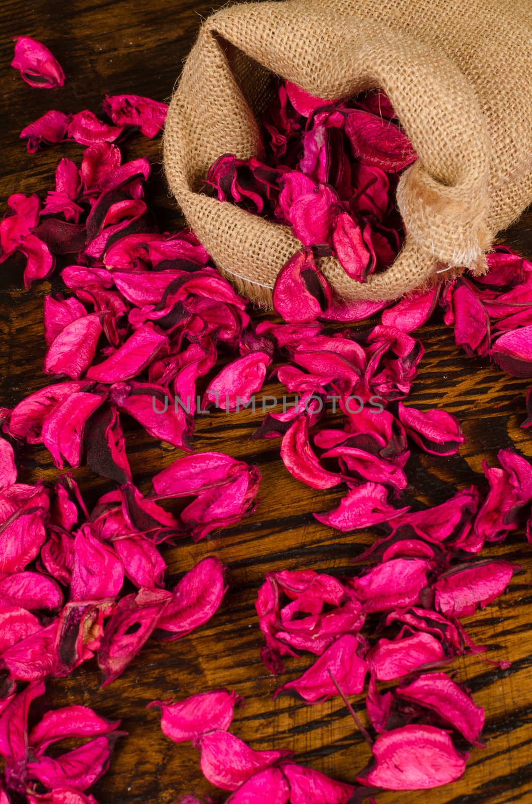 Dried flower petals scattered from inside a sack