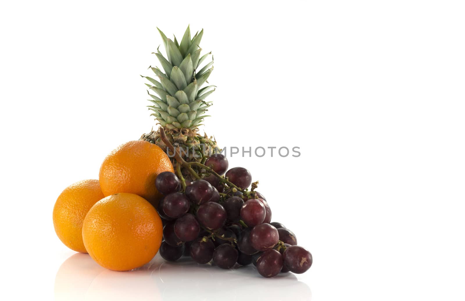 red grapes oranges and pineapple  fruit isolated on white