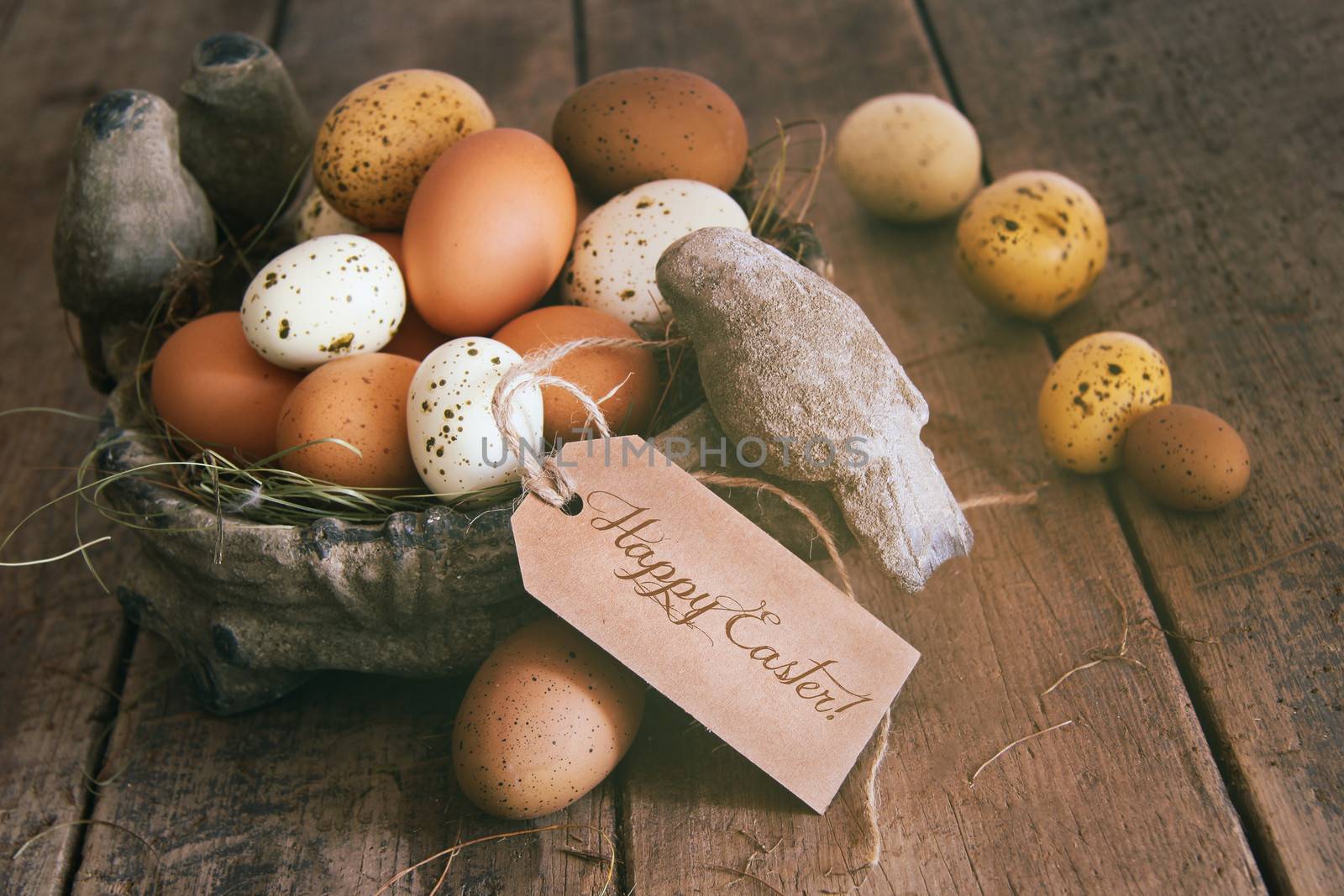 Assorted eggs in basket with note card by Sandralise
