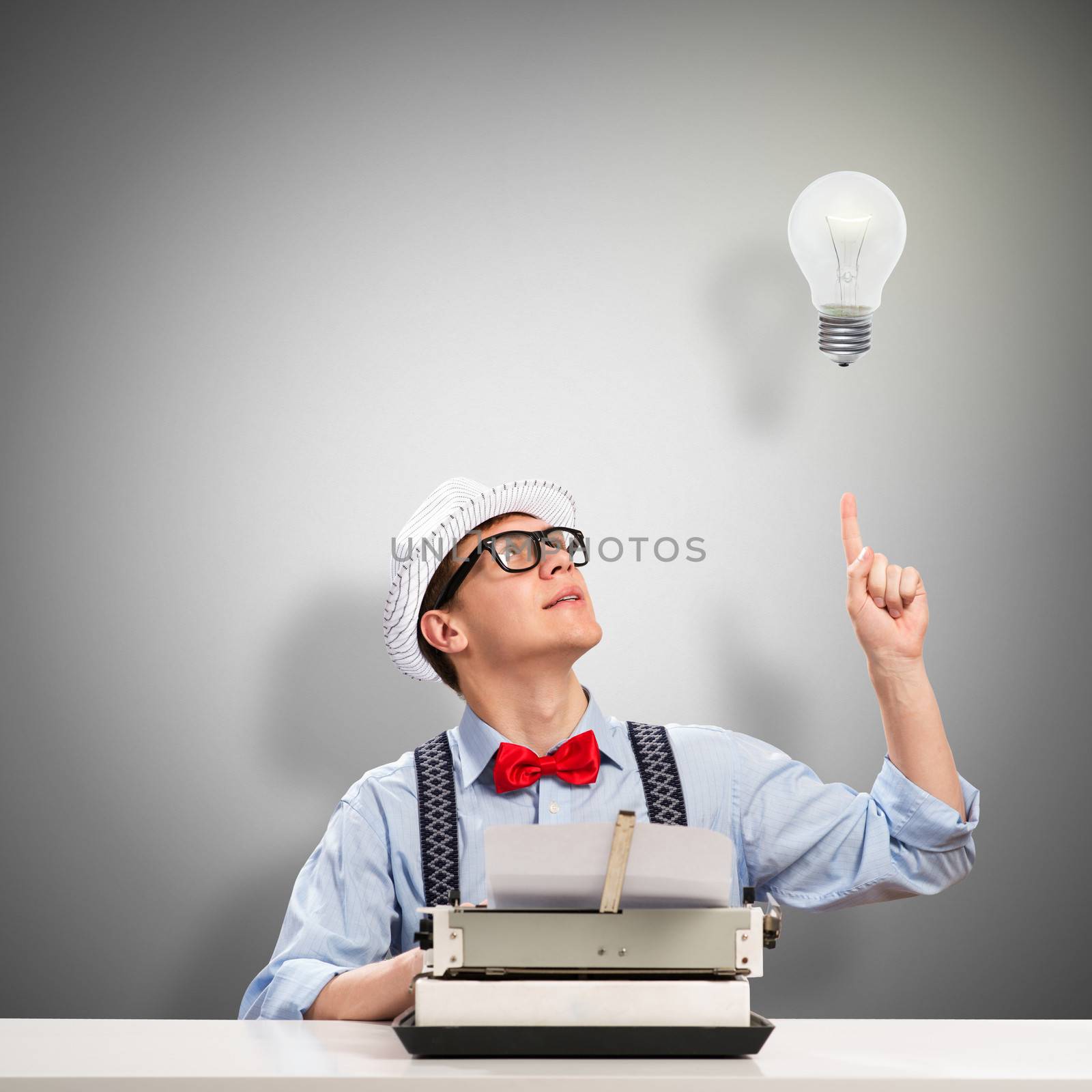 image of a young journalist, sitting at the table for a typewriter