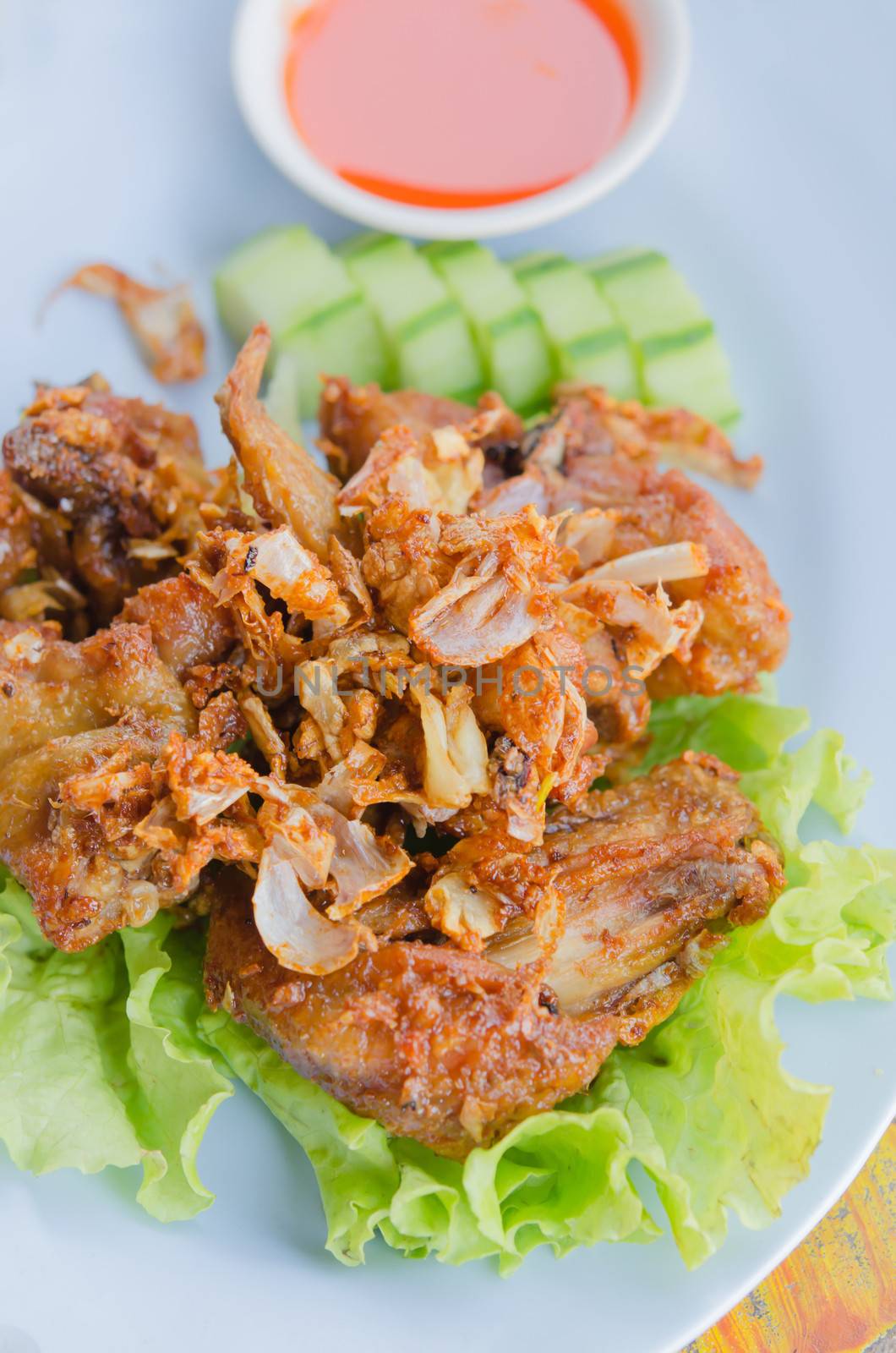 fried chicken served with fresh vegetable and chili sauce