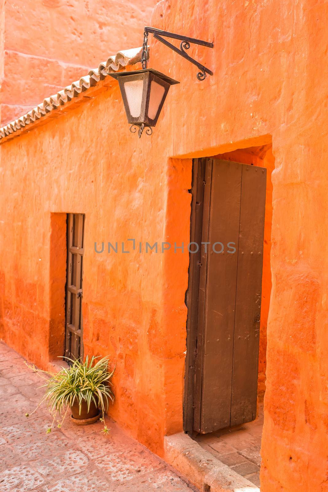 wooden door in orange hall in Santa Catalina monastery at Arequipa Peru