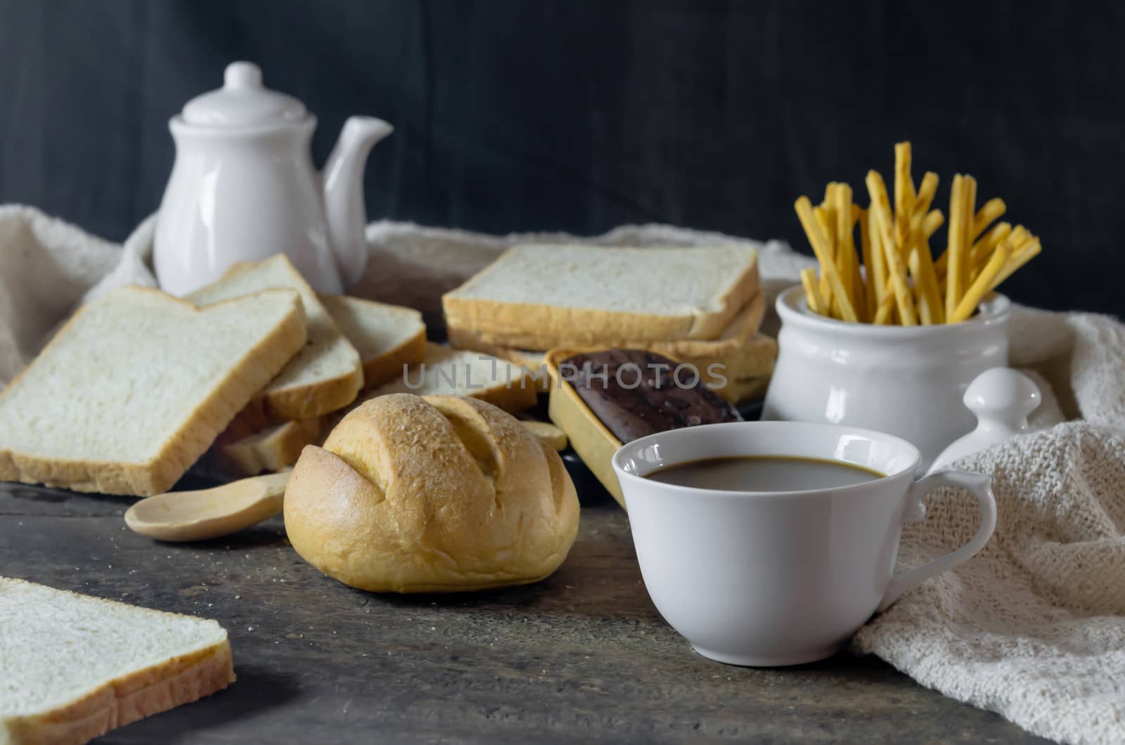 hot coffee with fresh bread on wooden table ,  still life