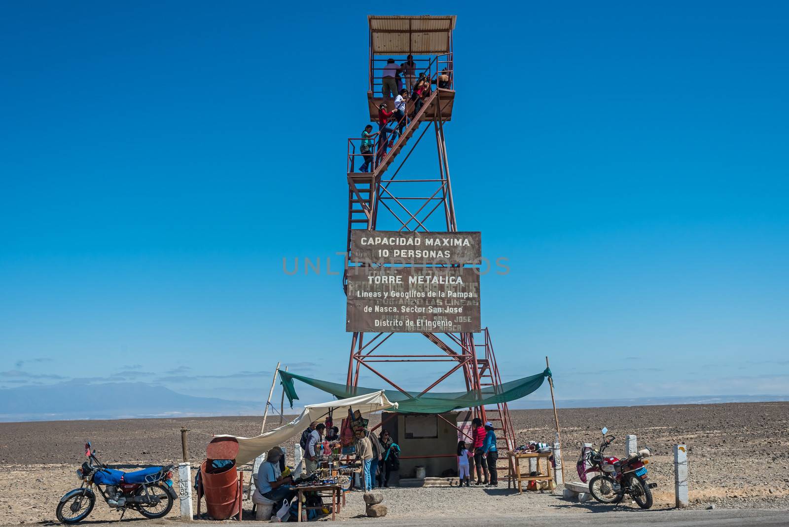 Nazca, Peru - July 31, 2013: people at the nazca lines observation tower in the peruvian coast at Ica Peru on july 31, 2013