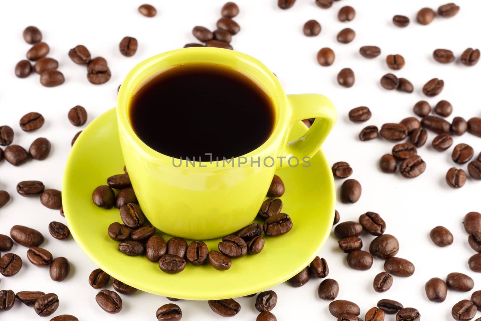 Coffee cup with coffee beans on white background.