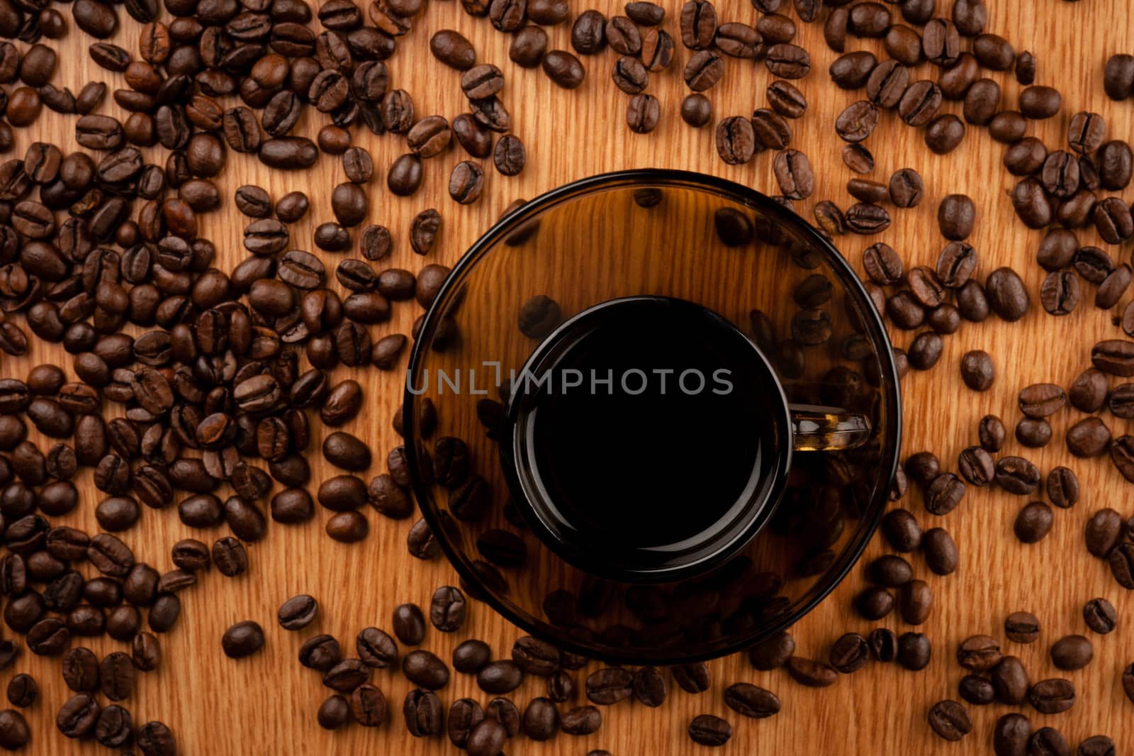 Coffee cup on wooden table with coffee beans
