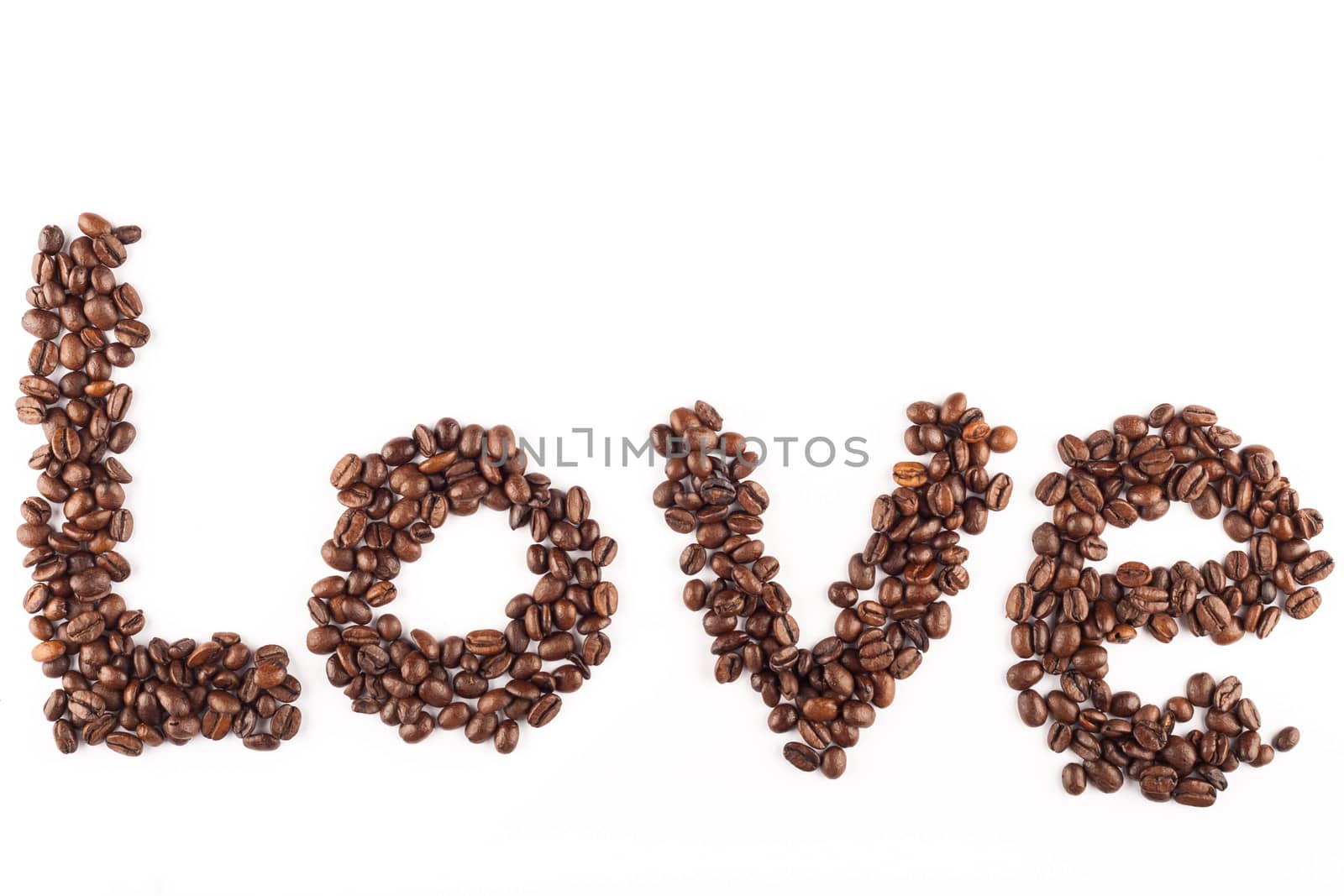 Coffee beans arranged in the word love.