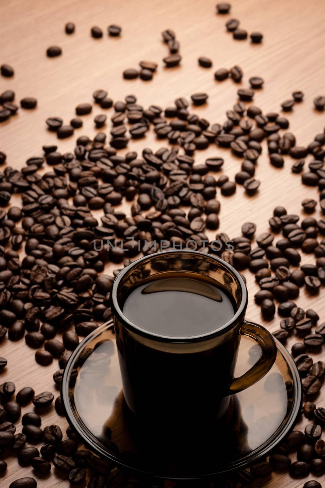 Coffee cup on wooden table with coffee beans