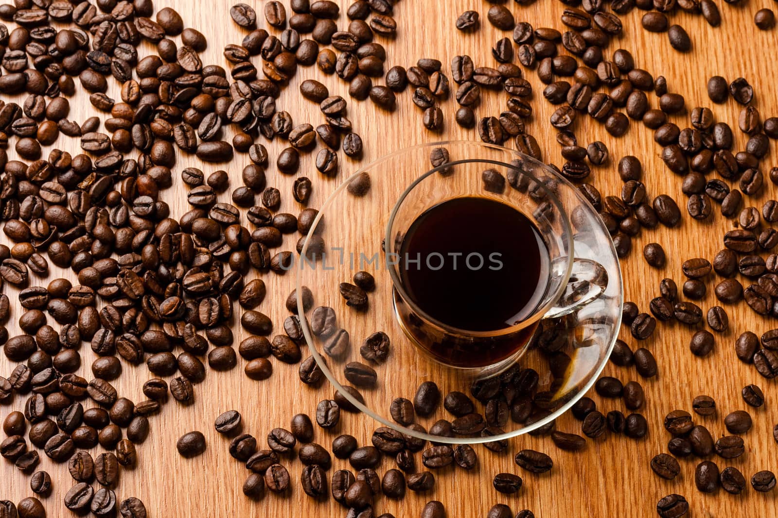 Coffee cup on wooden table with coffee beans