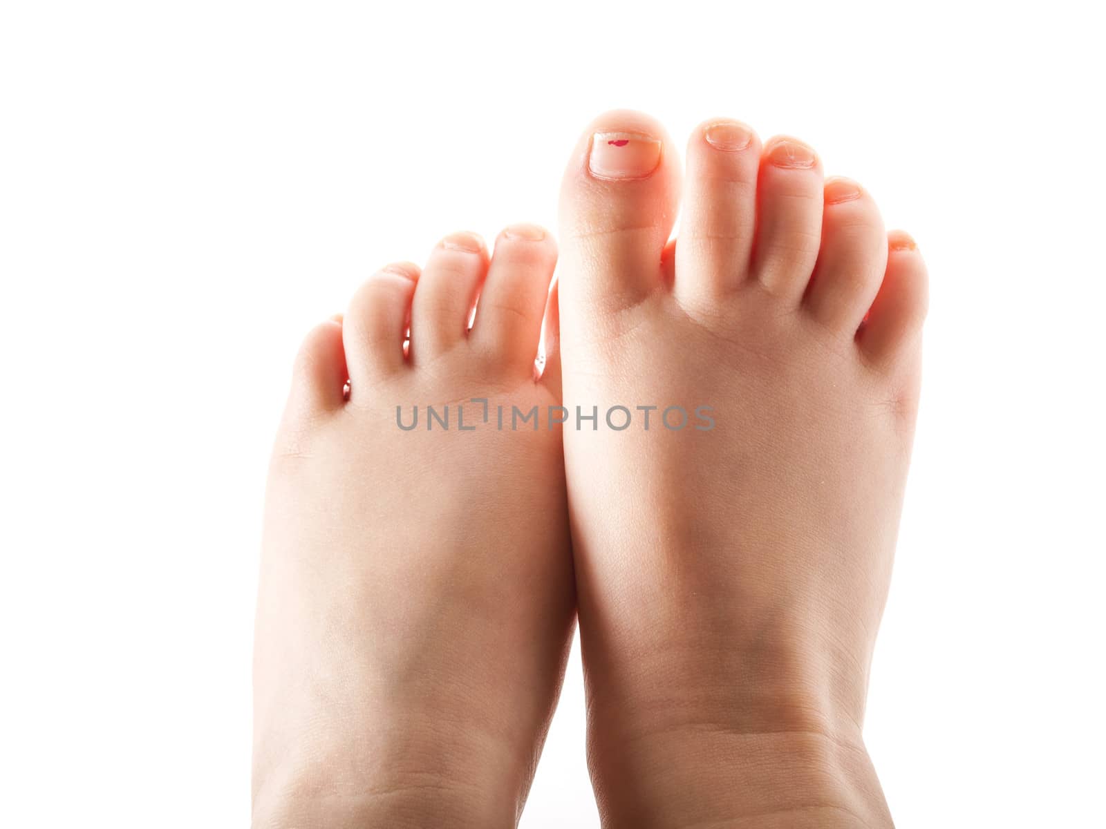 Small feet of a girl, isolated towards white background