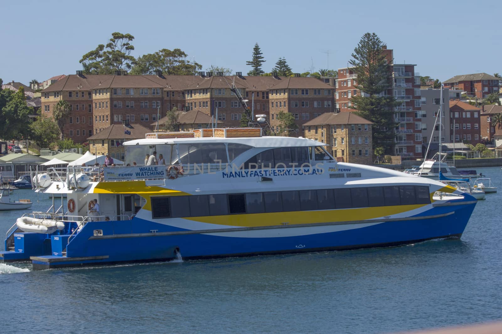 MANLY, AUSTRALIA-DECEMBER 19TH 2013: The Manly Fast Ferry leaving Manly harbour for Circular Quay. The fast ferry competes the journey in 15 minutes.