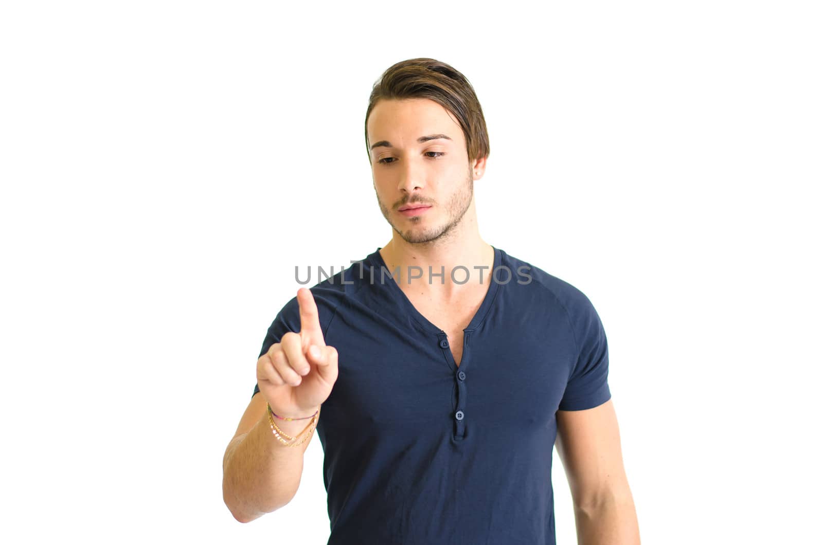 Attractive young man pressing imaginary button in the air with his finger. Isolated on white