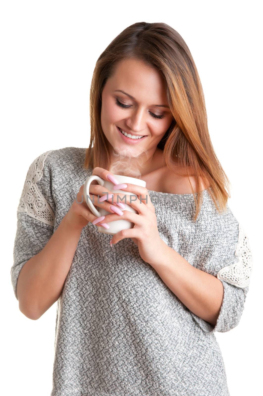 Woman smelling a cup of coffee, ready to drink it, isolated in white