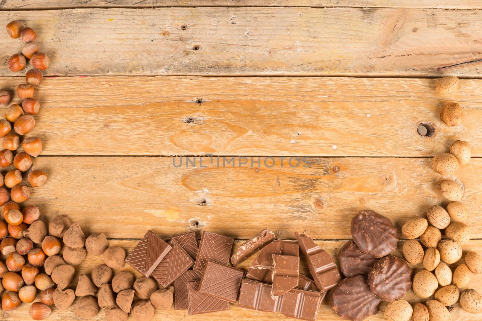 Nuts and candy displayed on a rustic wooden table