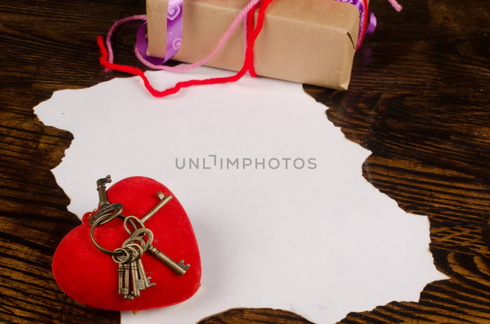 AValentines present next to a parchment for a message