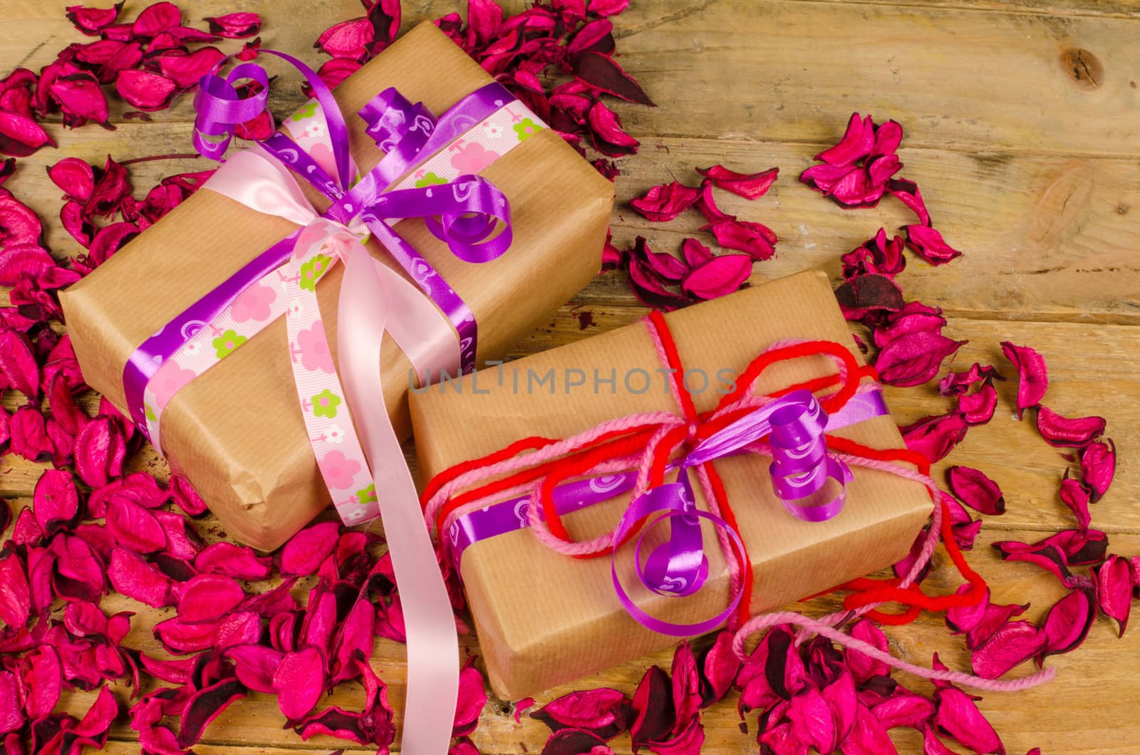 Fancy Valentines day gift boxes surrounded by dried flower petals