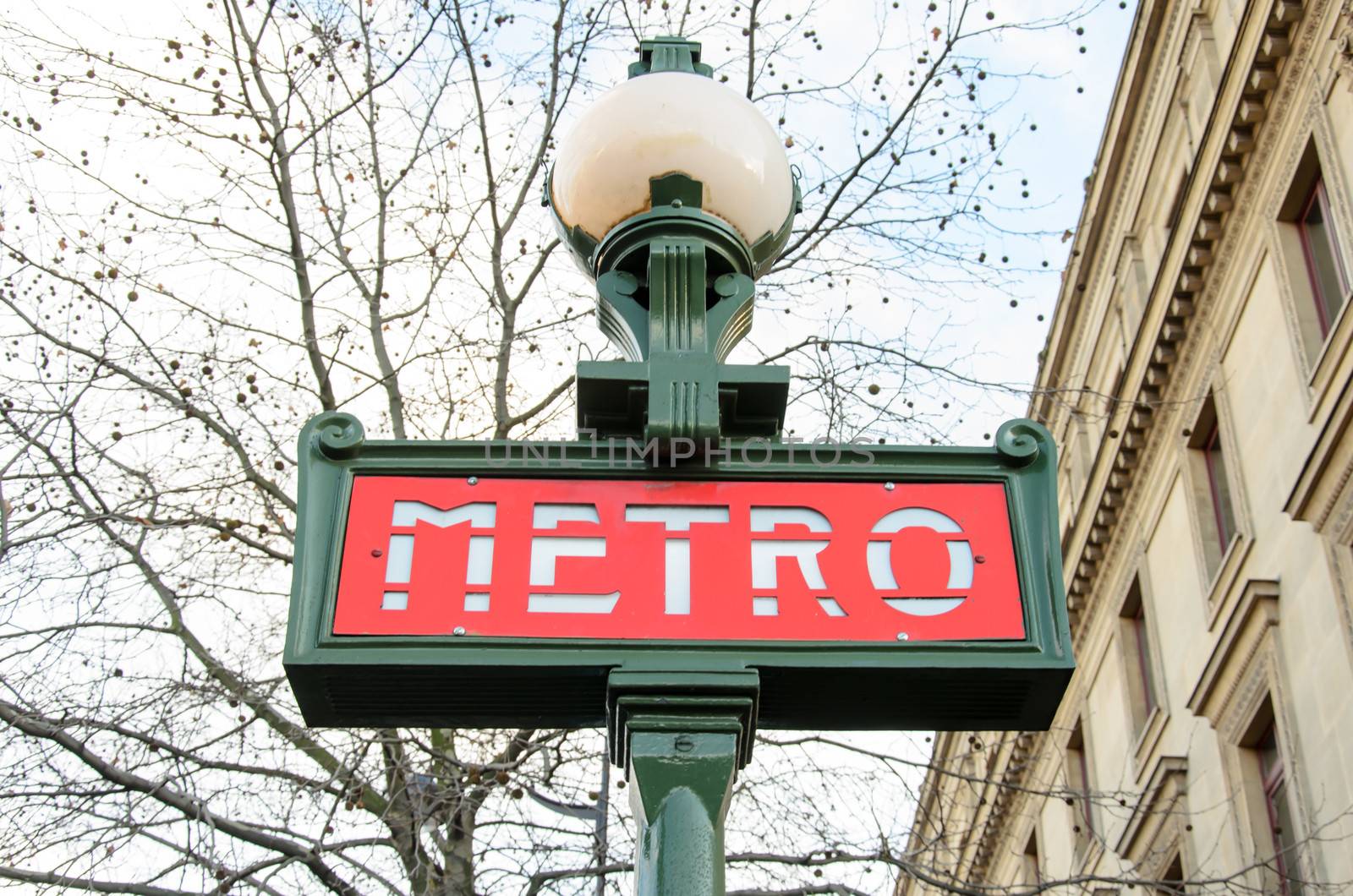 Metro Sign And Street Lamp In Paris