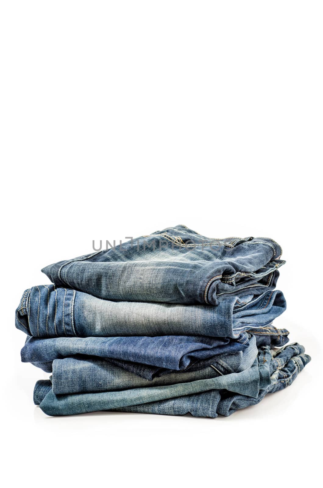 Folded Old Blue Jeans Isolated on a white. Clipping path included.