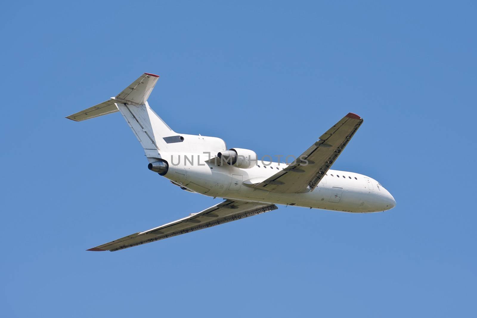 Beautiful white passenger airplane in blue sky