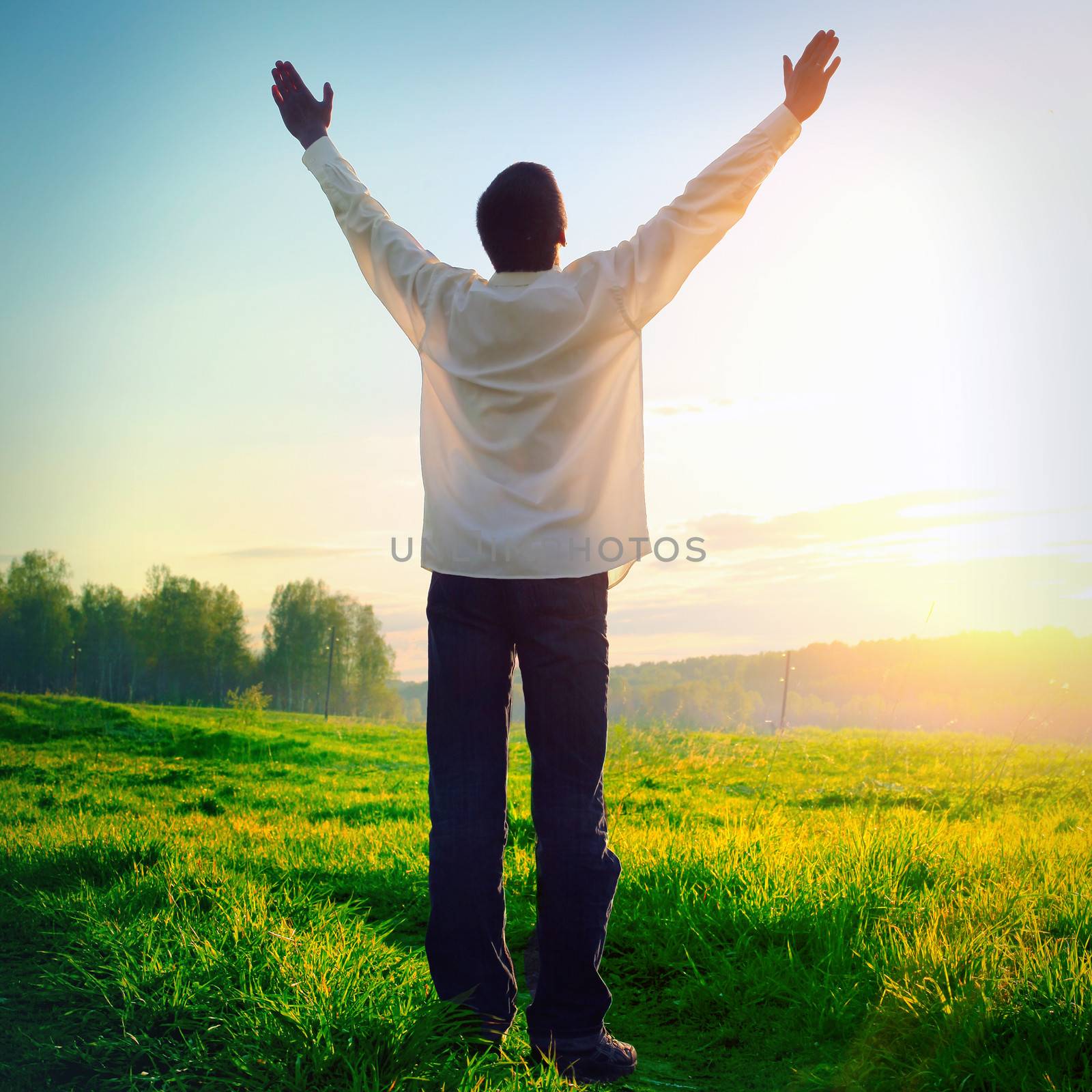 Toned photo of Praying Young Man on Sunset Background at Summer Nature