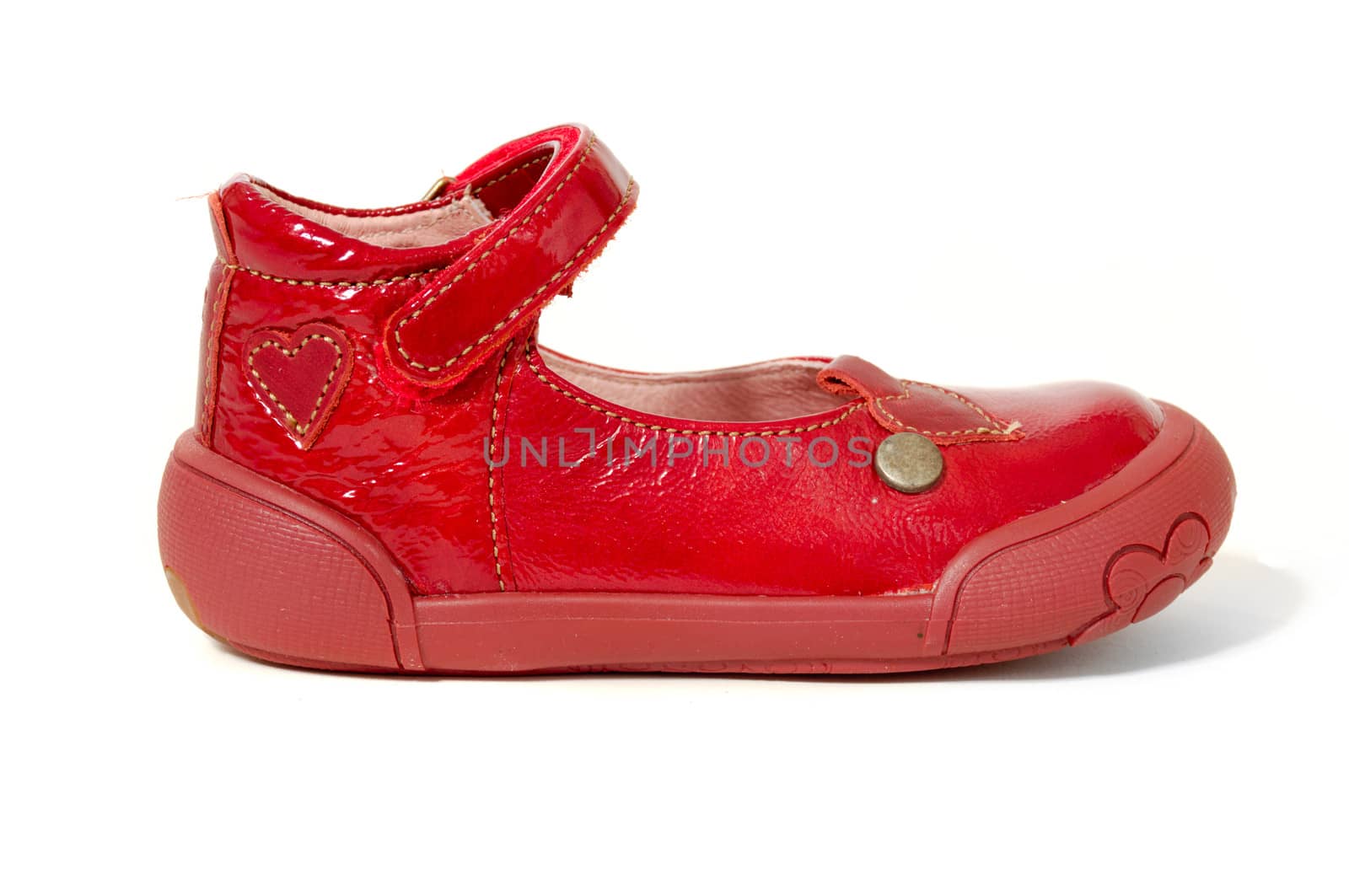 A red childs shoe. Taken on a clean white background.