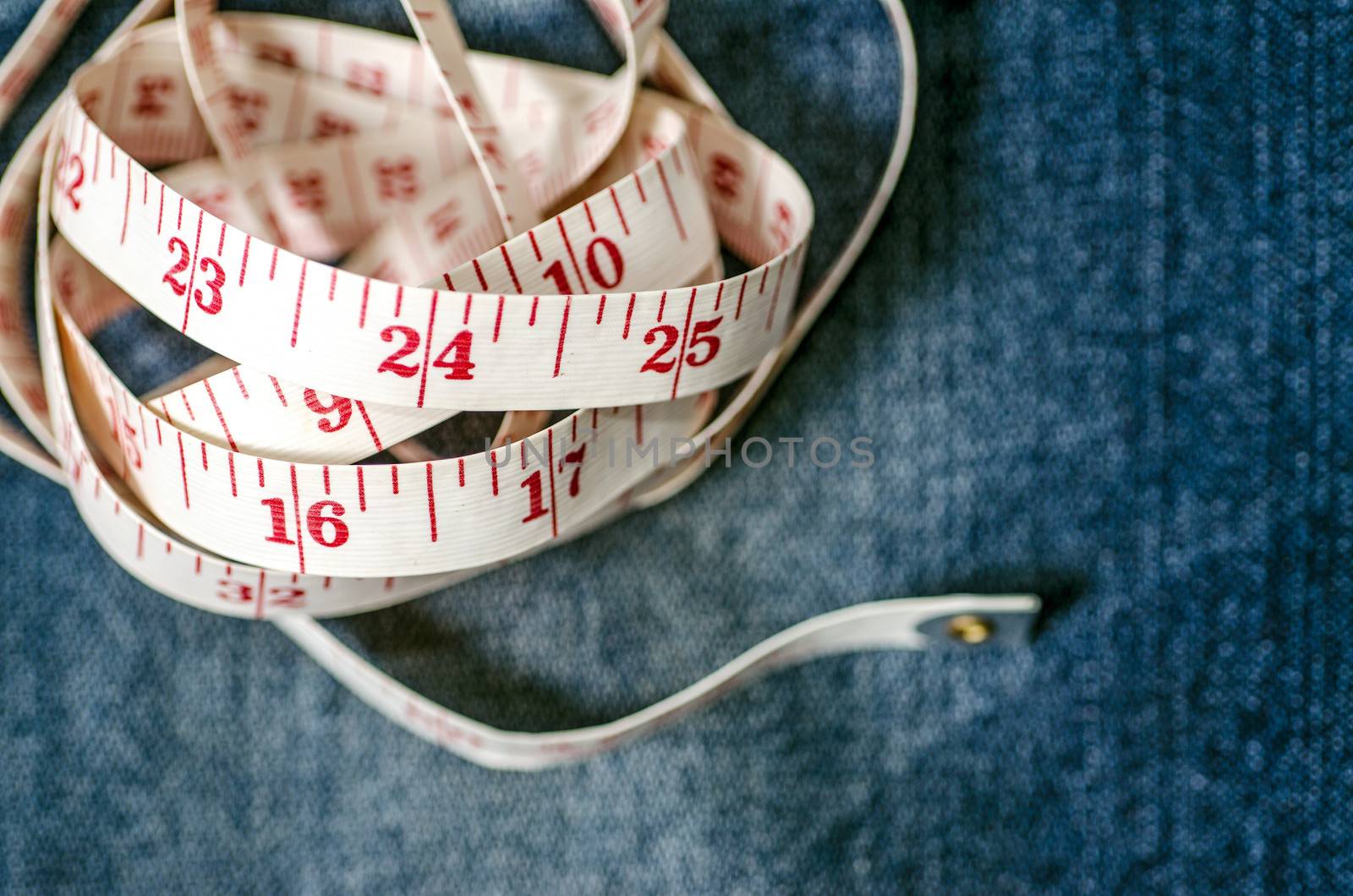 Measure tape on jeans :Selective focus by 9george