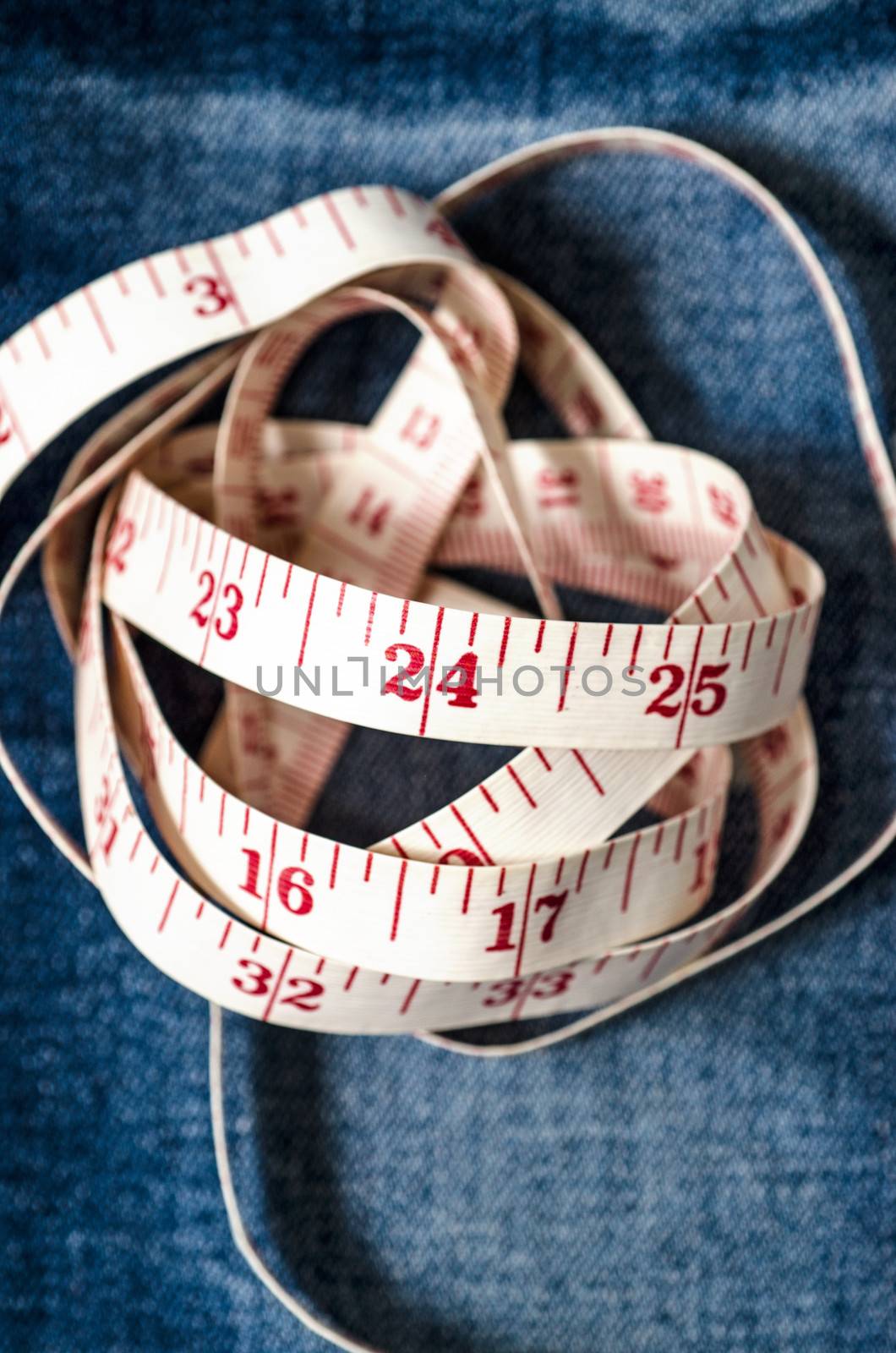 Measure tape on jeans :Selective focus by 9george