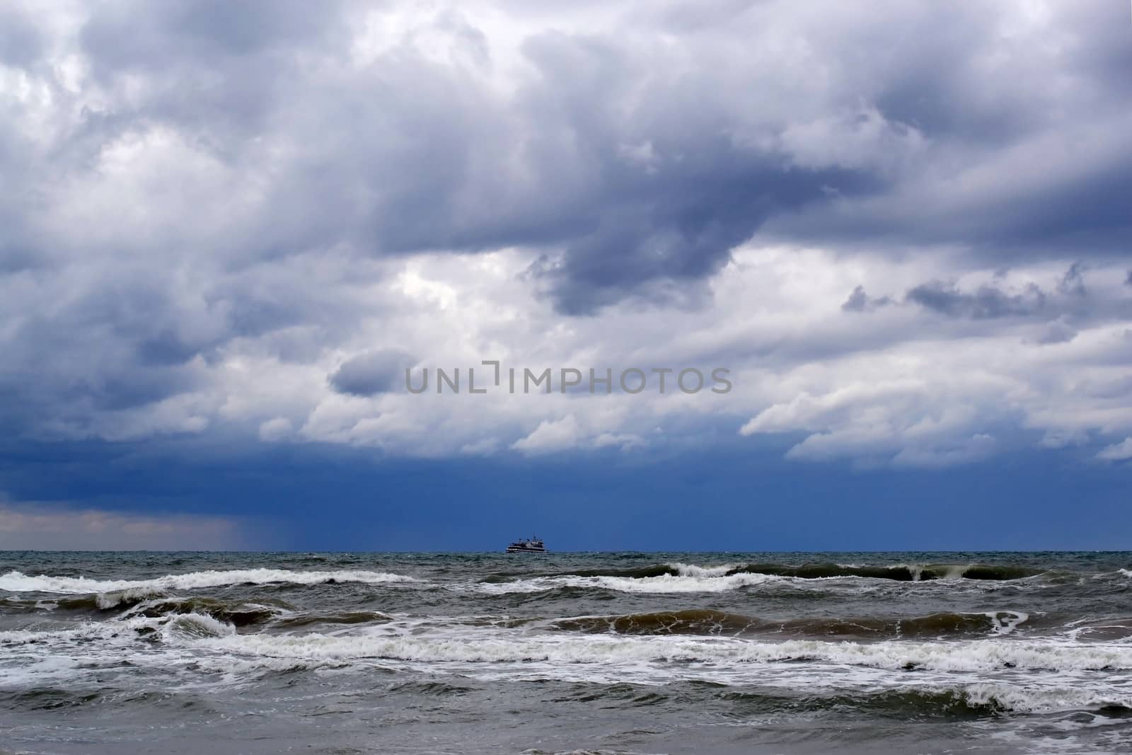 Waves of the Black Sea, Anapa, Krasnodar Krai. The ship in the sea on the horizon.