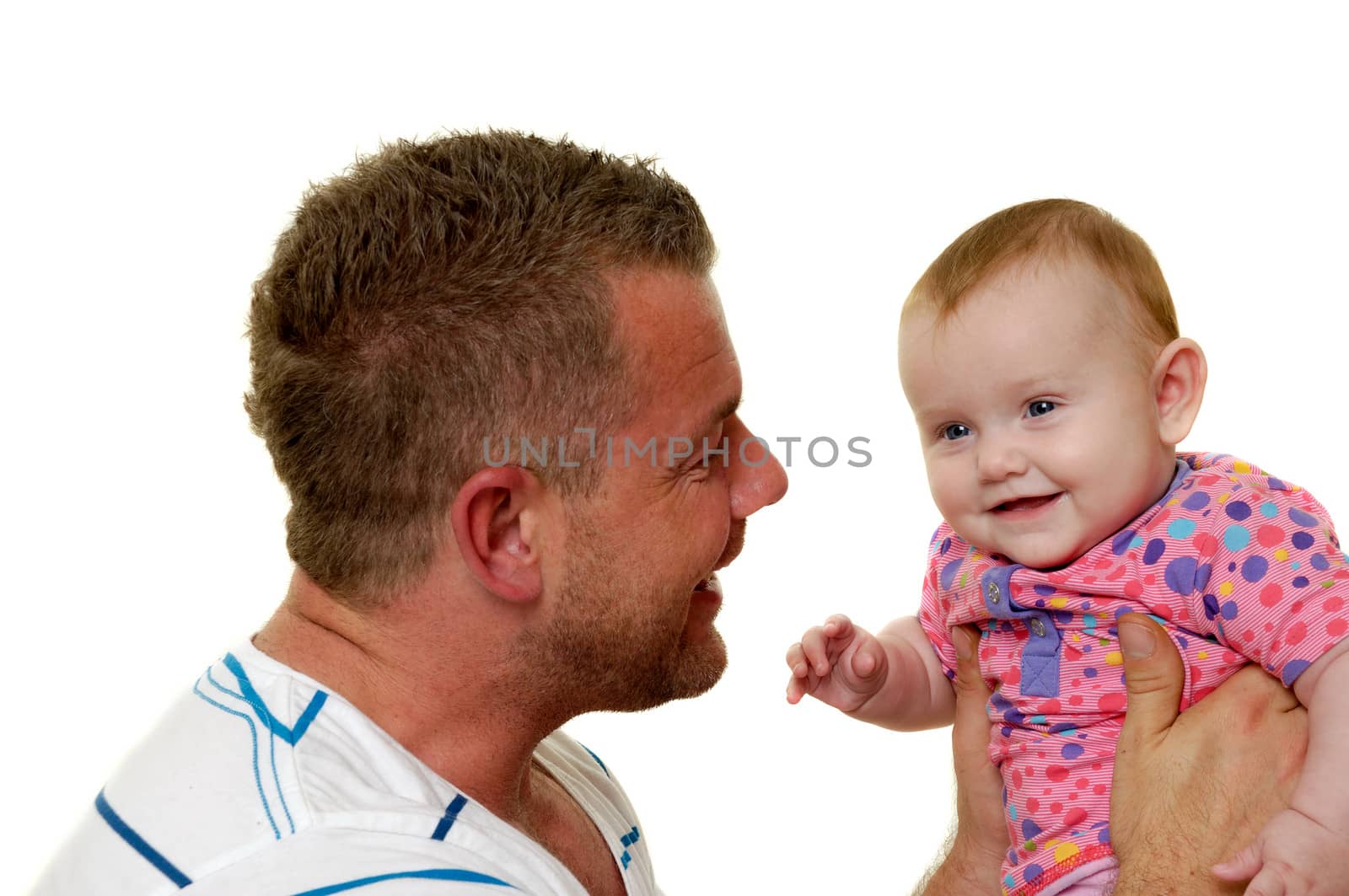 Baby and father are playing. They are both smiling and are very happy together.  The baby 3 month old. Isolated on a white background.