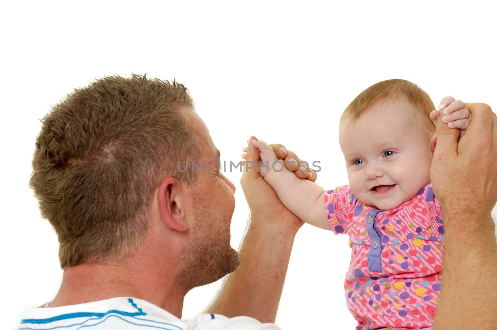 Baby and father are playing. They are both smiling and are very happy together.  The baby 3 month old. Isolated on a white background.