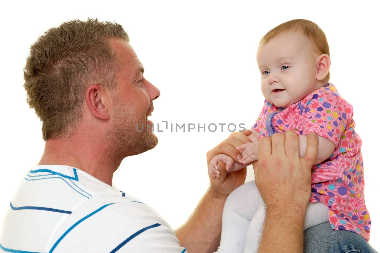 Baby and father are playing. They are both smiling and are very happy together.  The baby 3 month old. Isolated on a white background.