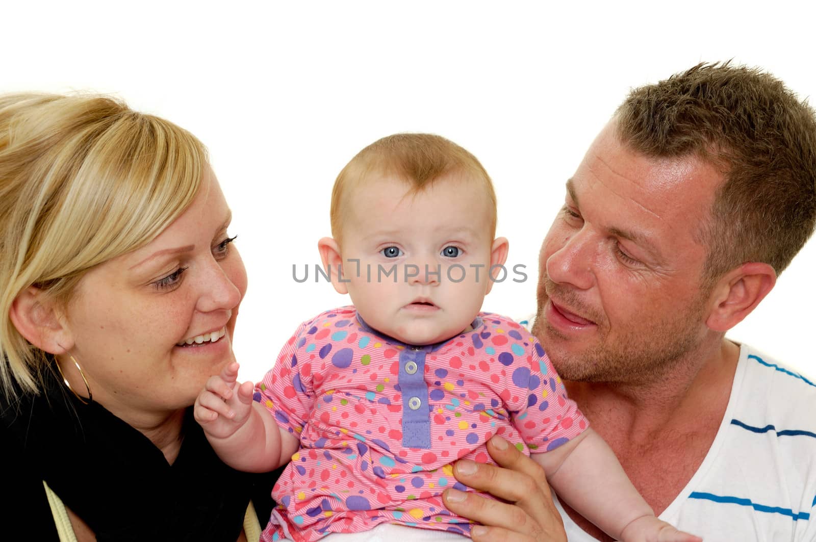 Happy family. Mother and father are looking at their sweet smiling 4 month old baby.