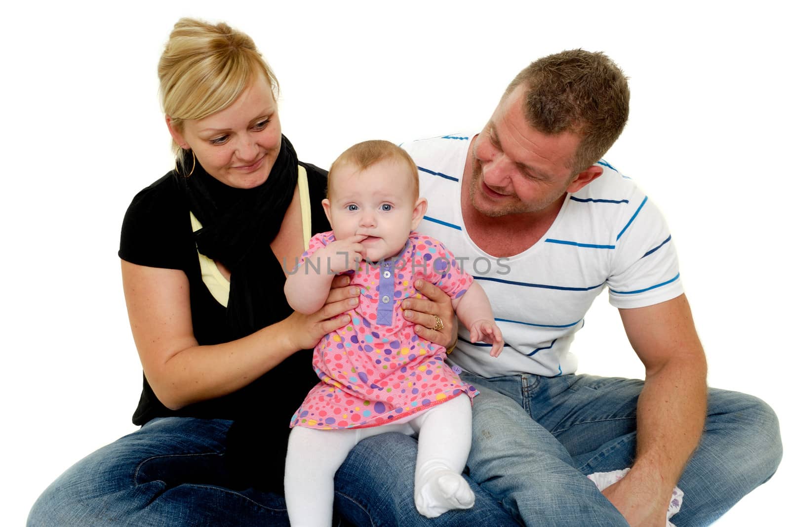 Happy family. Mother and father are looking at their sweet smiling 4 month old baby.