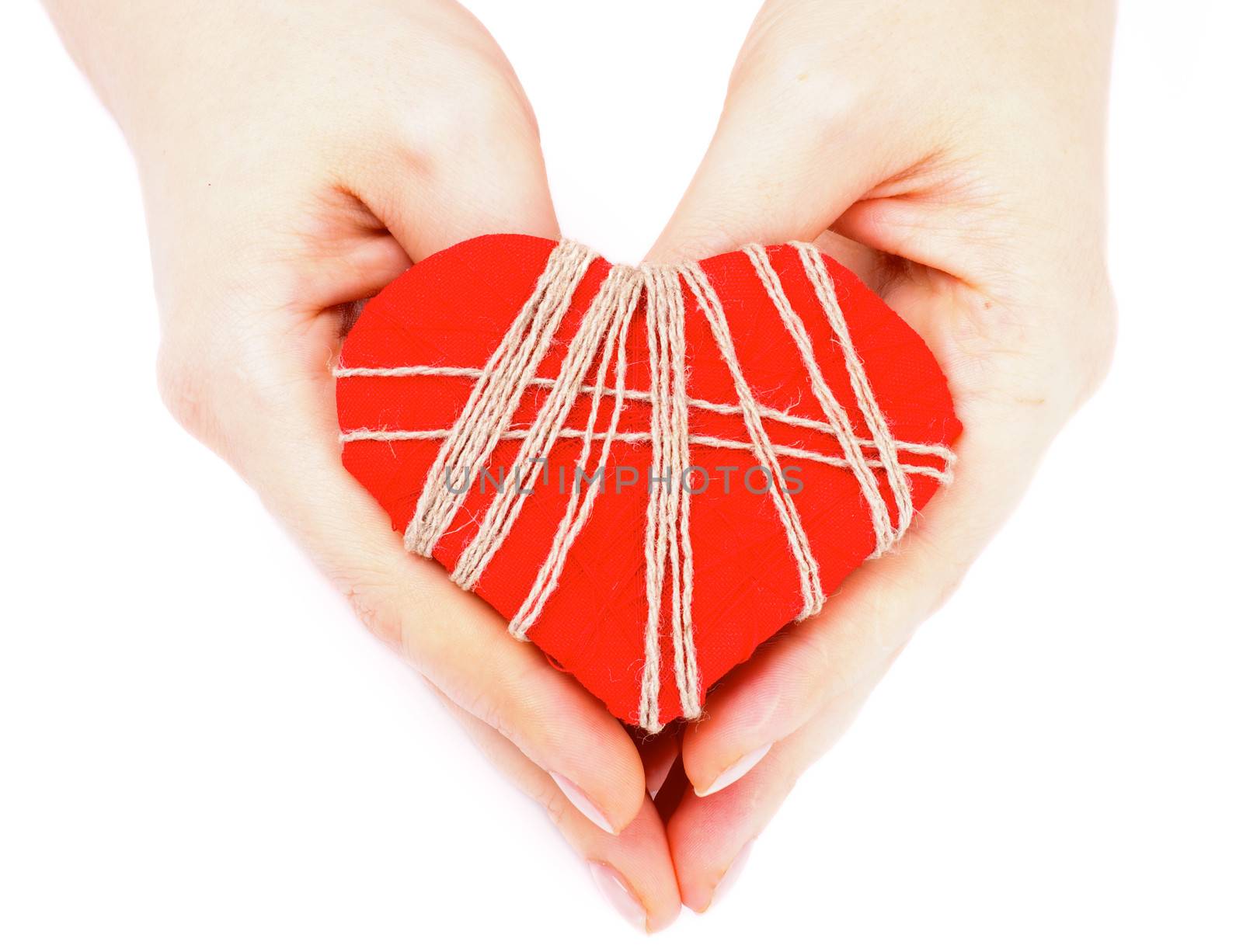 Handmade Valentine Red Heart Decorated with Threads in Woman Hands isolated on white background