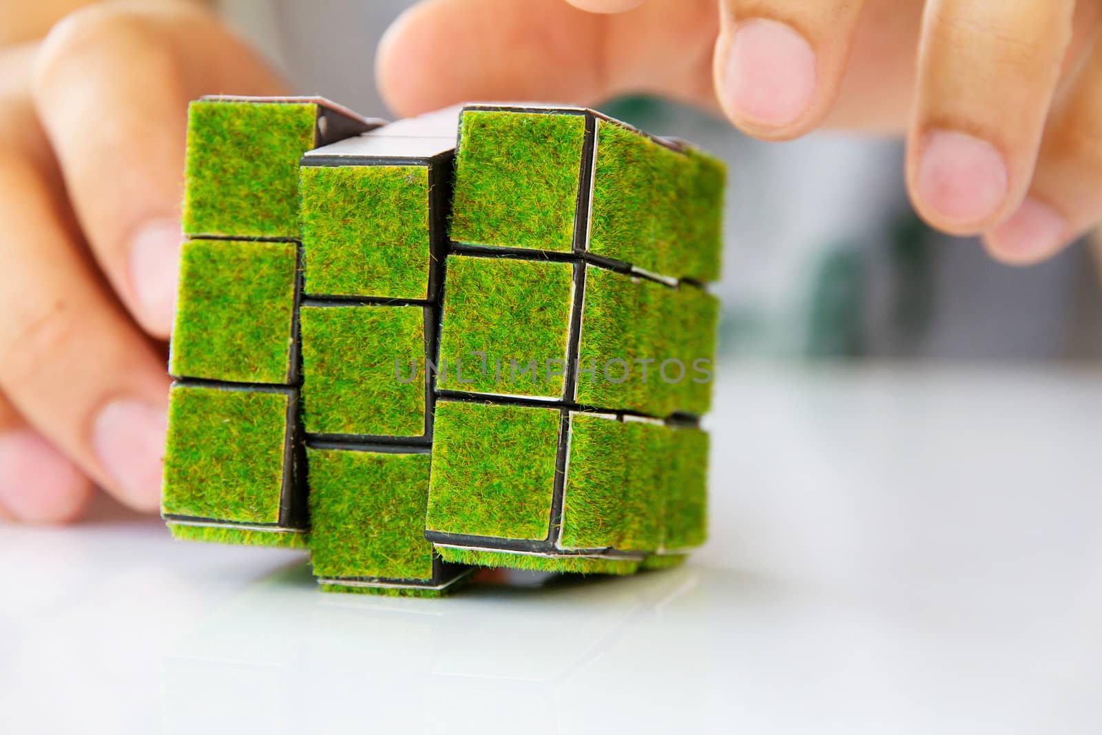 hand holding green rubik's cube concept