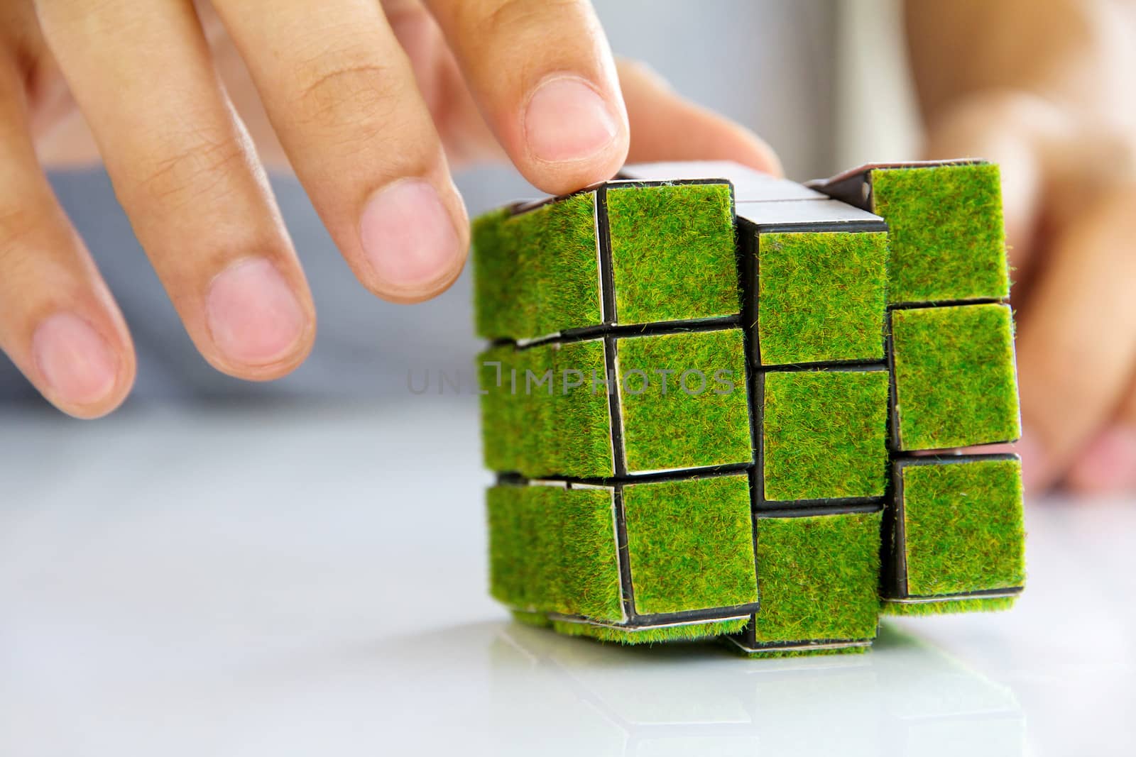 hand holding green rubik's cube concept