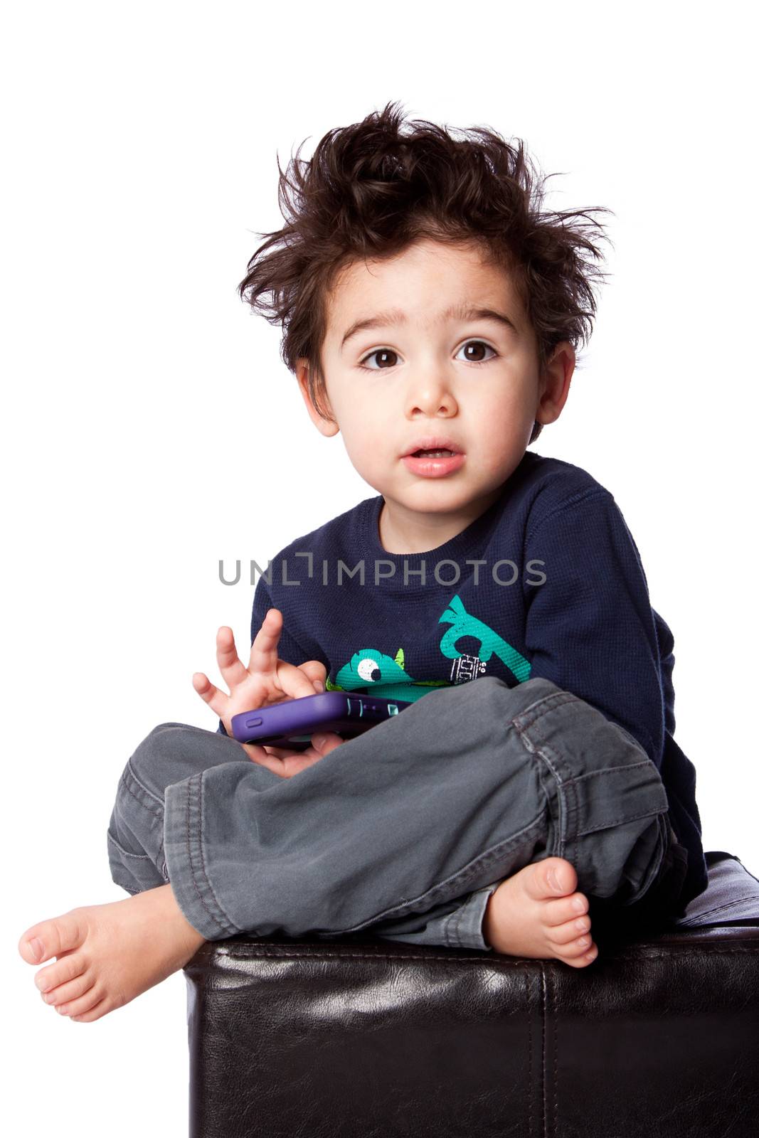 Cute boy sitting with mobile device by phakimata