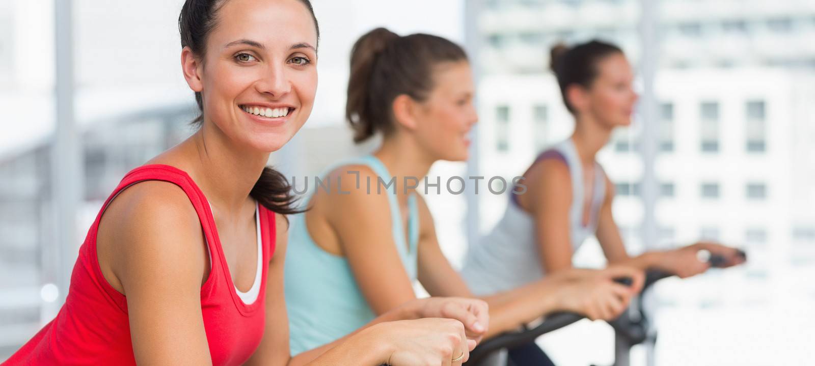 Fit people working out at spinning class by Wavebreakmedia